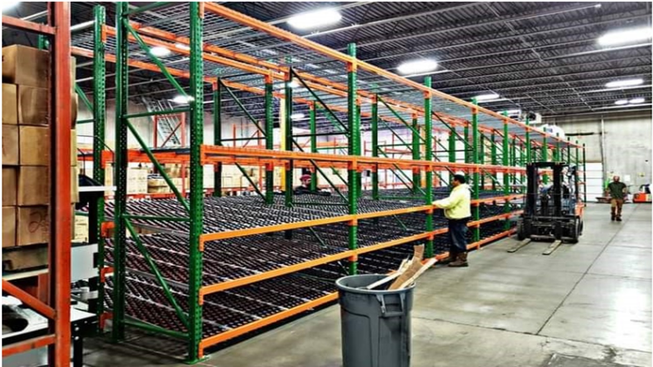 Large multi-level pallet racking system with orange and green structure