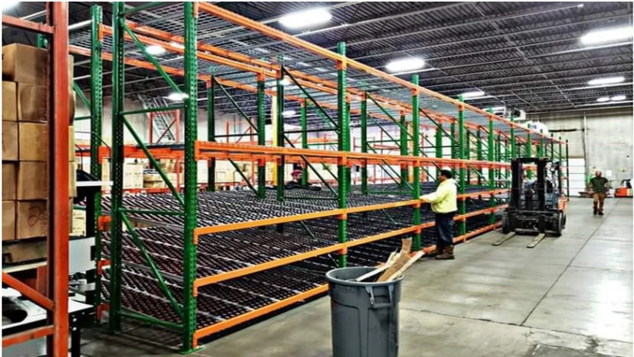 Large multi-level pallet racking system with orange and green structure