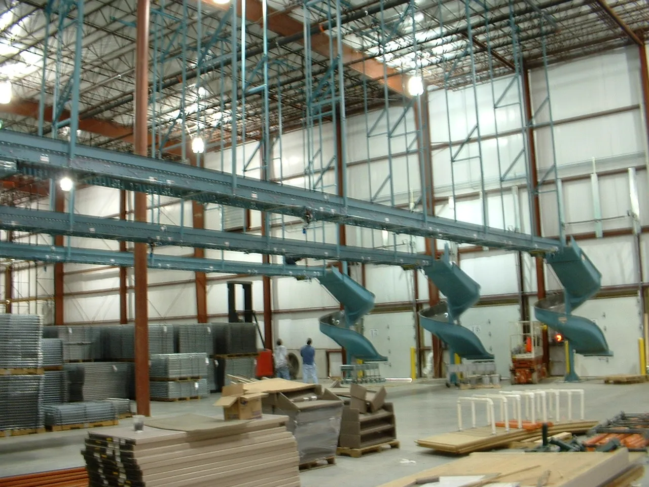 Overhead view of spiral decline chutes and multi-level conveyor system in a warehouse