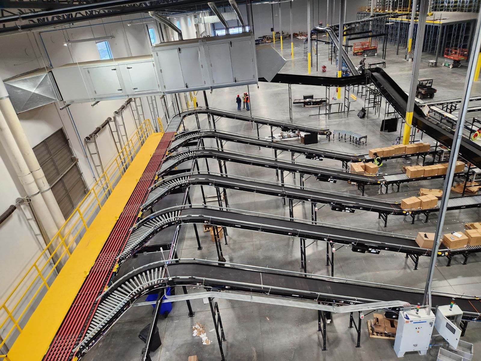 Complex multi-level overhead conveyor system with curves and automation in a large facility