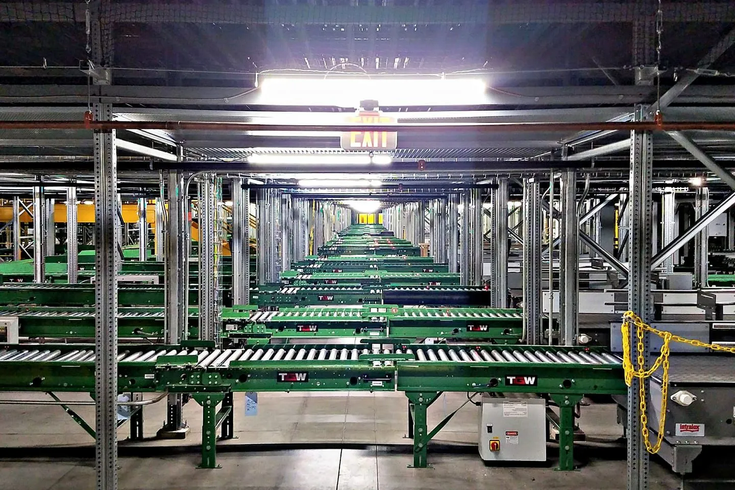 High-capacity green TGW conveyor system in a tall modern distribution facility